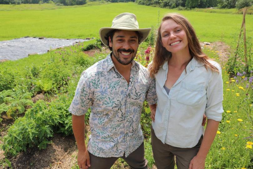 Armando and Erica in front of herb bed