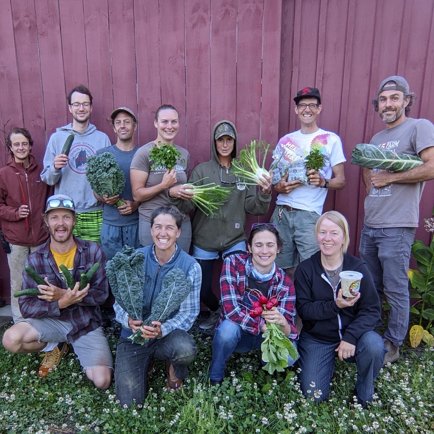 Root 5 staff poses with produce outside a barn.