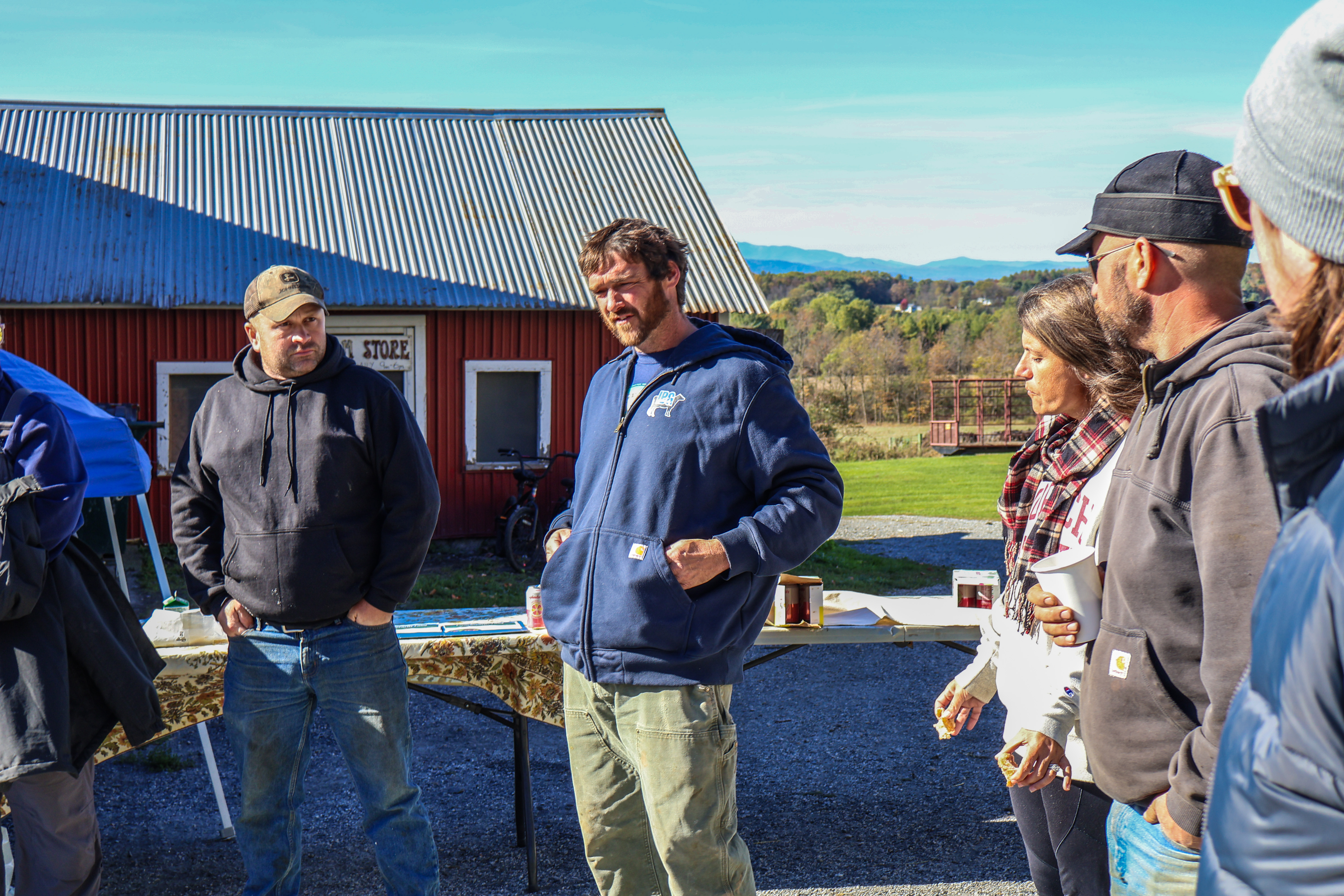 Jessie Wilbur of Lazy Dog Farm stands alongside farmer Jon Lucas, Jessie's wife Stefanie, and farmer Josh Lucas as they share drought impacts with the crowd of legislators and representatives from other key farm support organizations