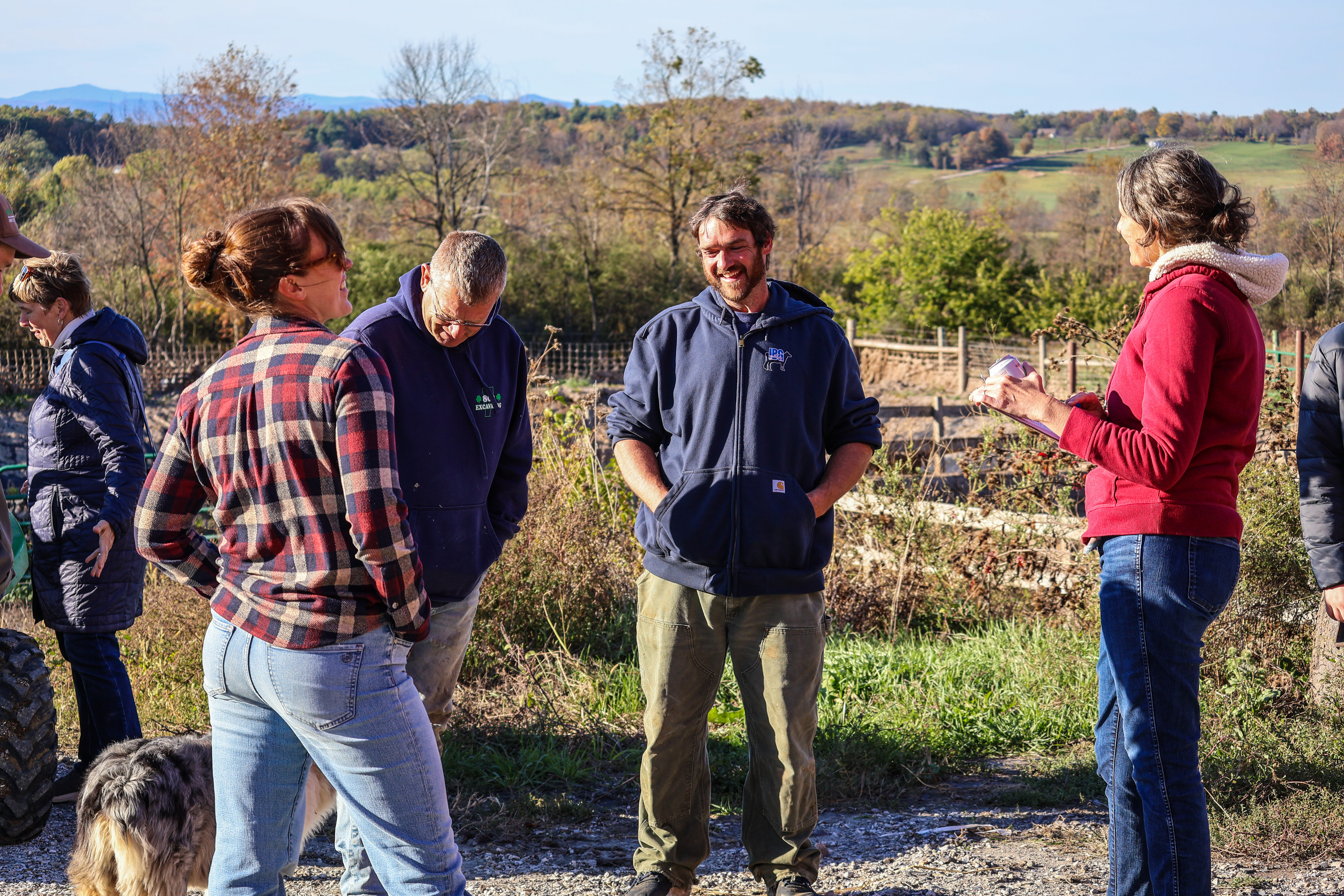 NOFA-VT's Policy & Organizing team, along with local legislators and ag service providers gathered at Lazy Dog Farm during the drought of 2025 to hear from farmers, including host Jesse Wilbur who stands in a circle on his farm speaking about the impacts of the drought on his operation