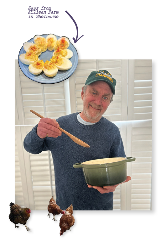 A person holds a pot and a big spoon, pretending to stir and smiling. There are two stickers overlaid, one of a plate of deviled eggs and one of chickens.