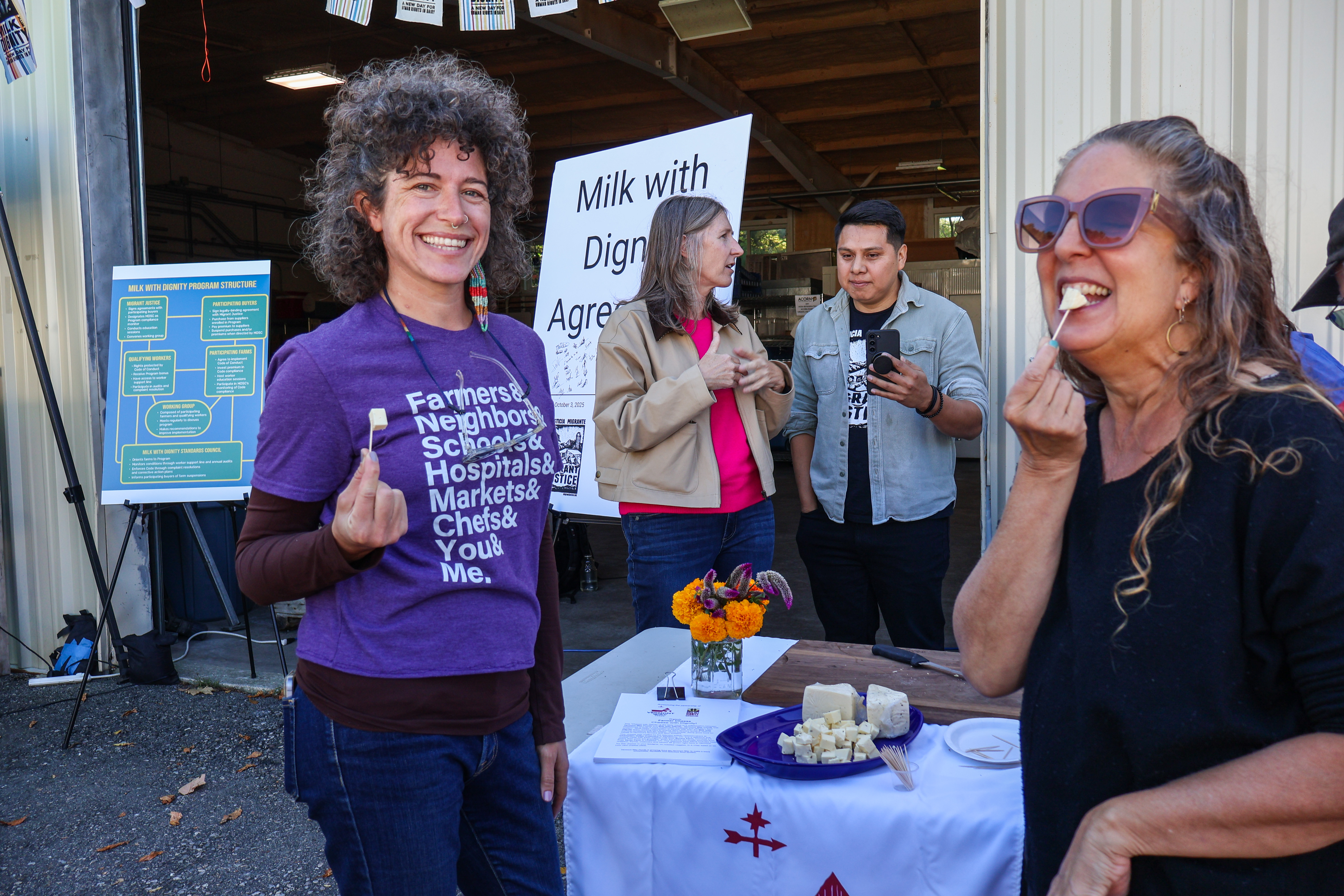 Lindsey Berk, Executive Director of ACORN, samples the new cheese with local activist and business owner Joanna Colwell
