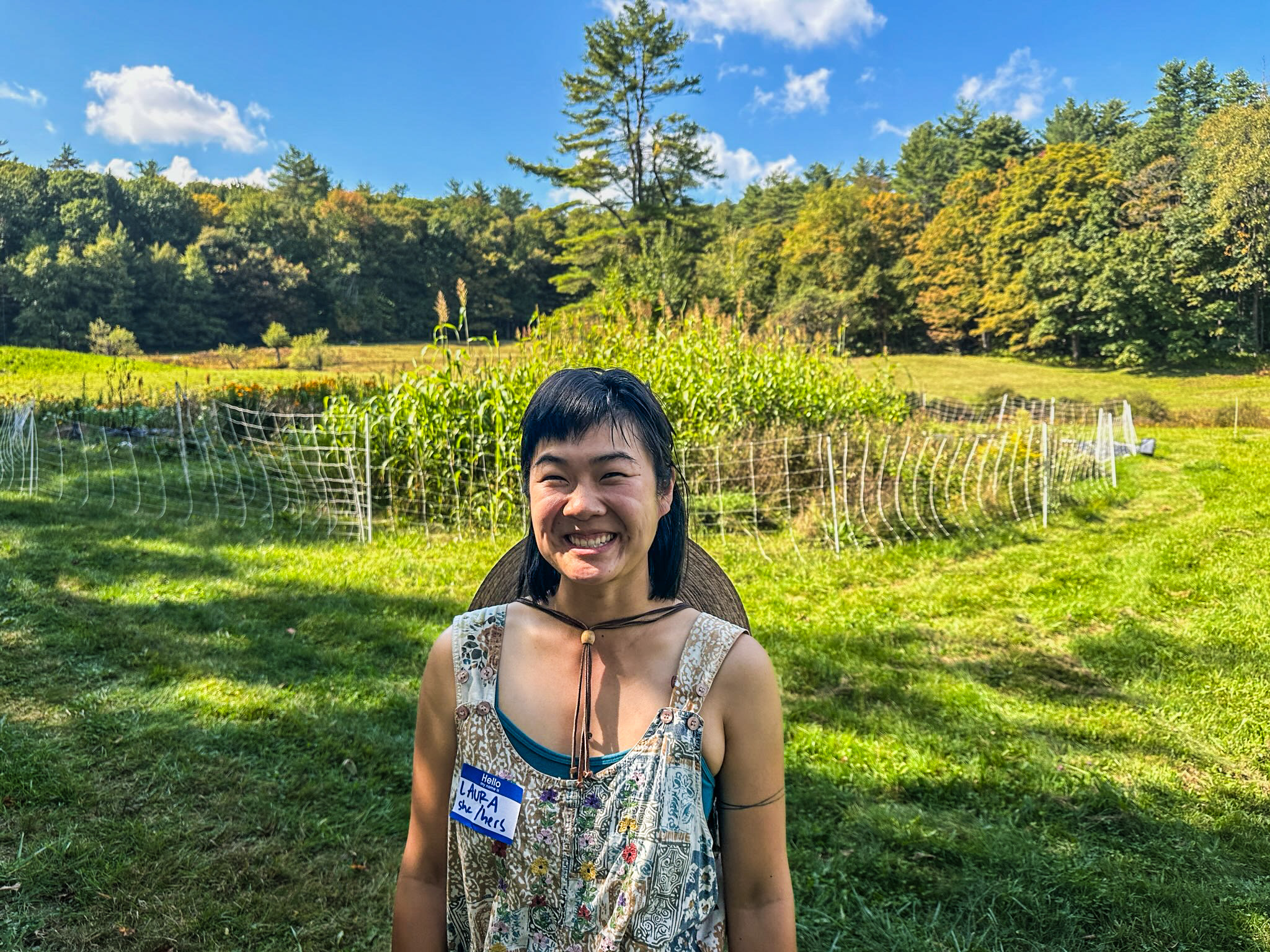 Laura Xiao of By Hand Farm stands beaming in front of her flower fields