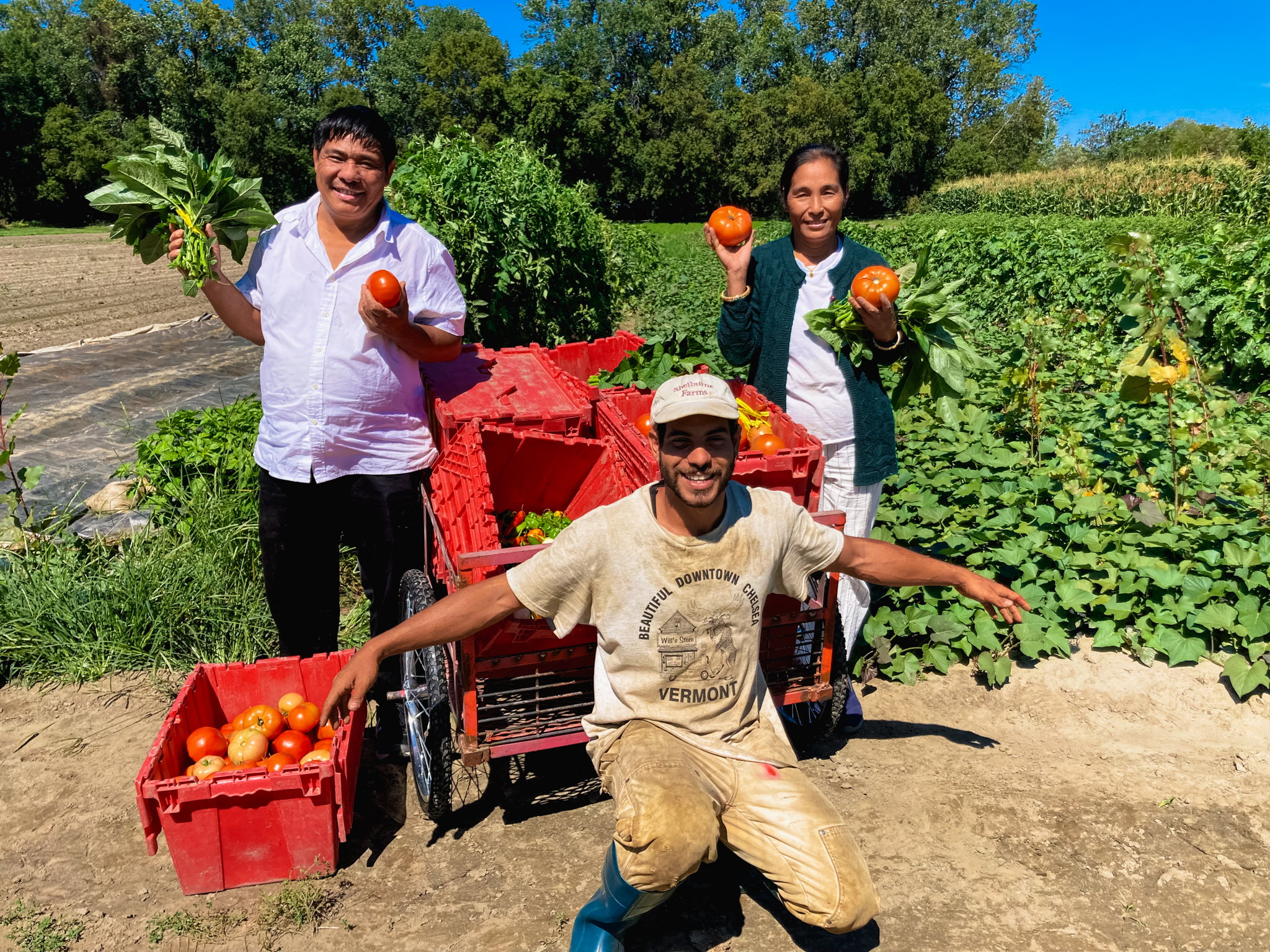 Volunteers Ash and Buddhi Tamang pose with Nour in front of The People’s Farmstand plot at Diggers’ Mirth Collective Farm in Burlington, VT. Ash and Buddhi first encountered People’s Farmstand at the South Meadows weekly pop-up event.