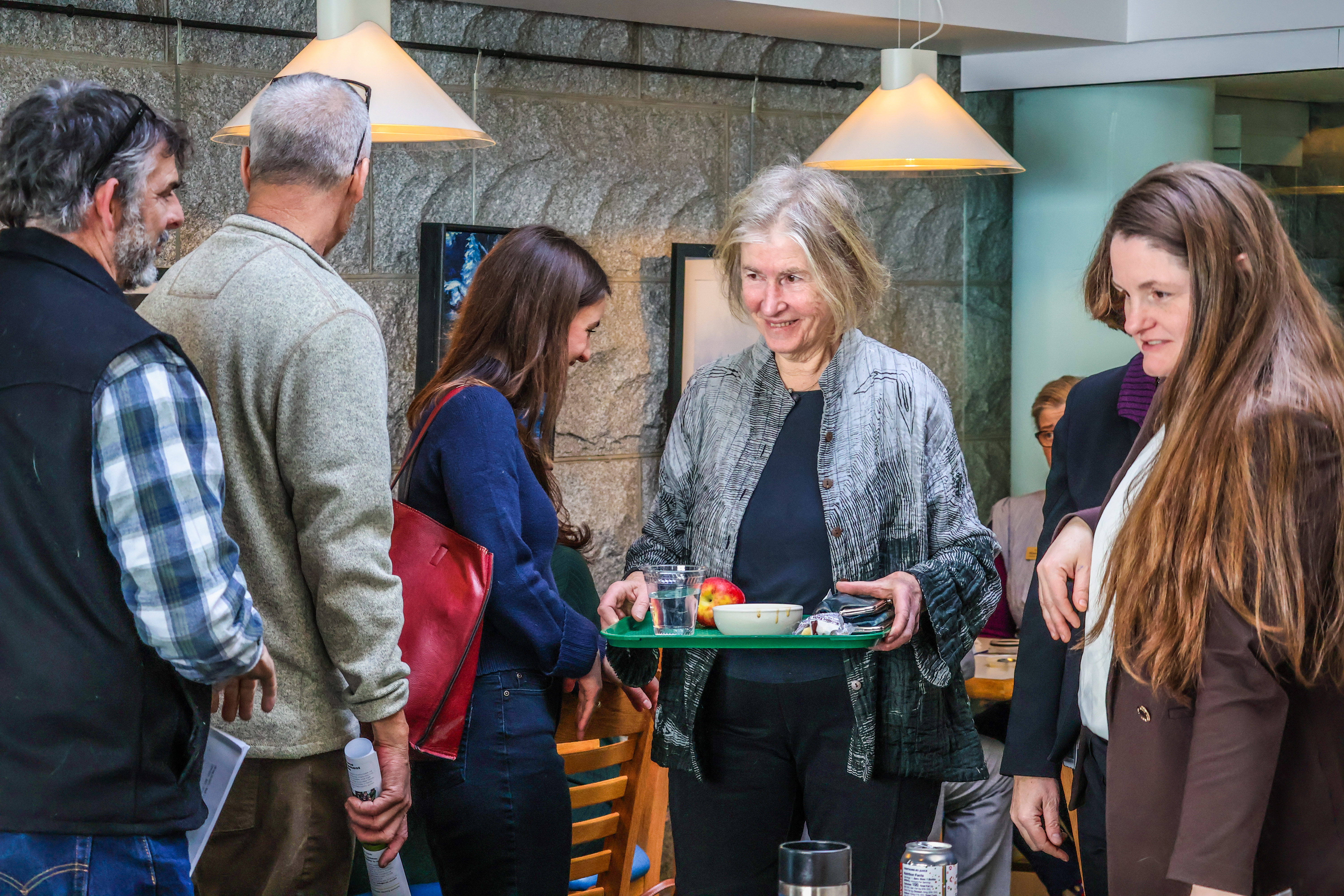 NOFA-VT member Susan Smiley moves through the State House cafeteria to join a table with her Representative, Jubilee McGill, to discuss NOFA-VT's policy priorities during a recent State House Day