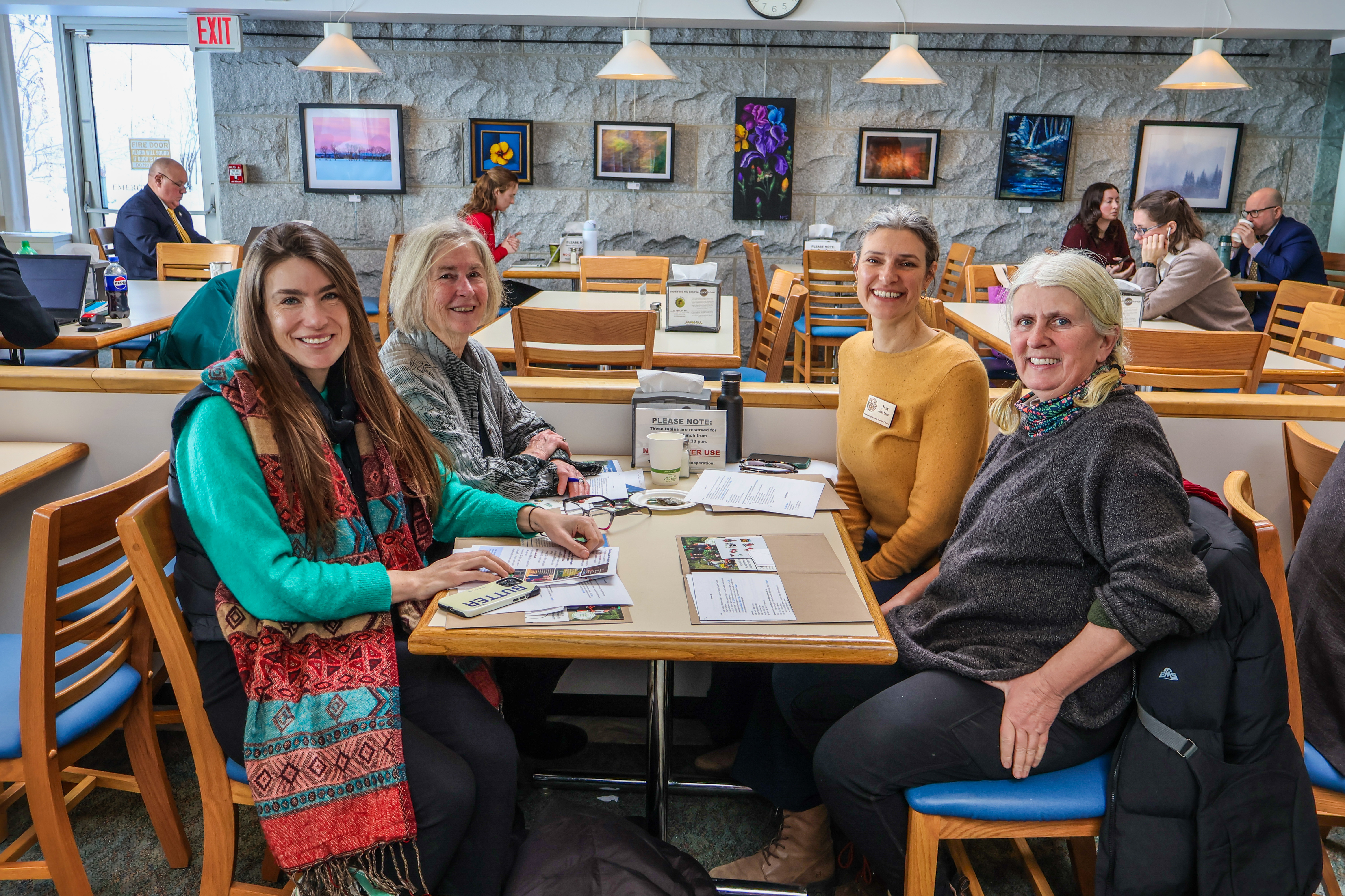 Grace Oedel, NOFA-VT Executive Director, sits at a State House cafeteria table with NOFA-VT member Susan Smiley, NOFA-VT farmer-member Margaret Loftus, and NOFA-VT Grassroots Organizer Jess Hays Lucas during a recent NOFA-VT State House Day advocating for our state policy priorities.