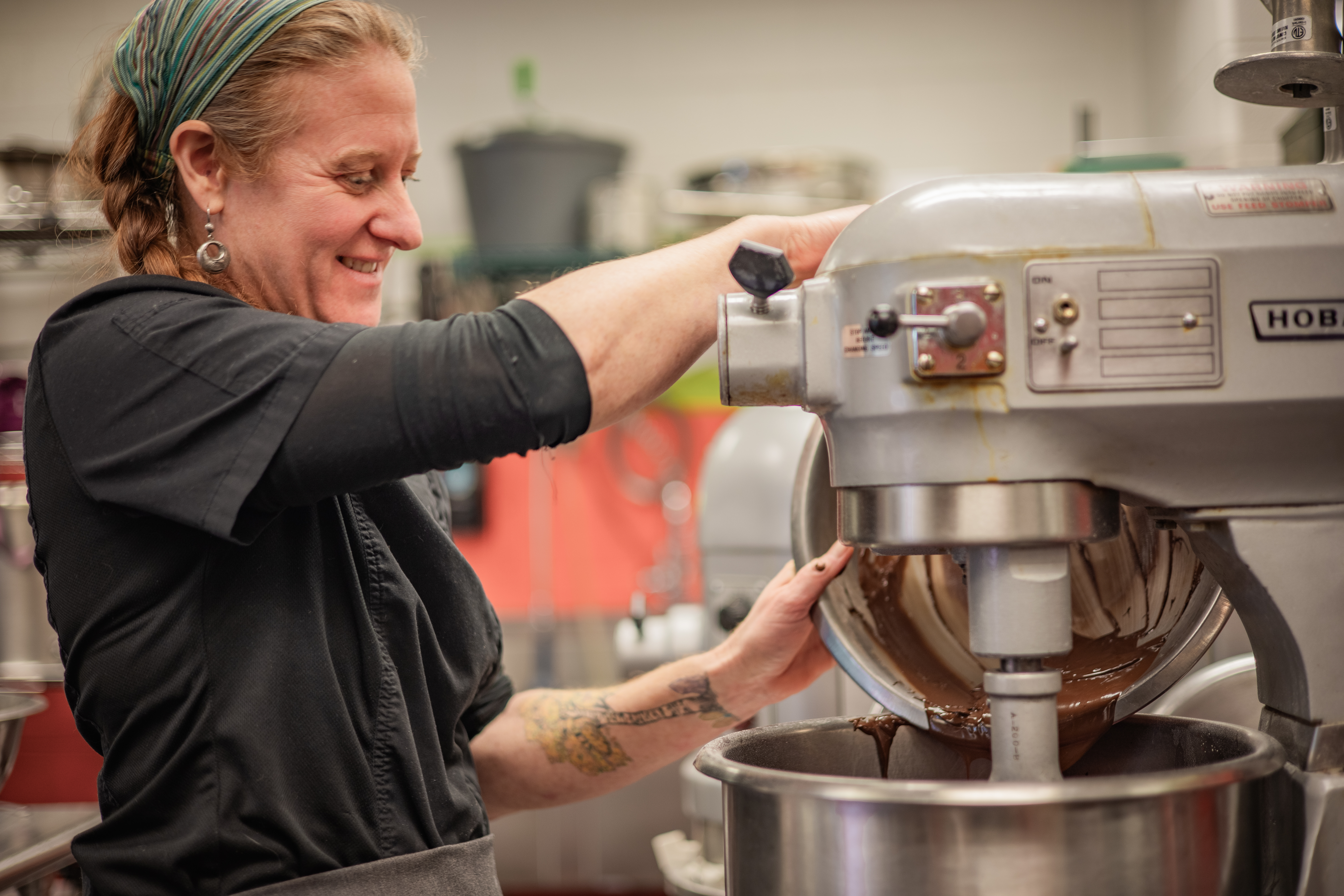 A food service professional whips up a batch of chocolate cake in the school cafeteria
