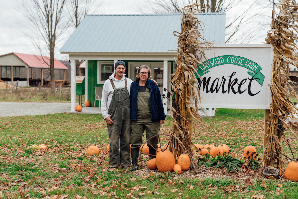 Dan and Laurie by the Wayward Goose farmstand sign