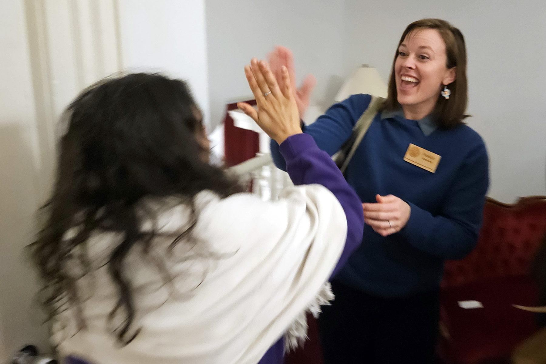 NOFA-VT Policy & Organizing Director Maddie Kempner is seen giving an enthusiastic high-five to NOFA-VT farmer-member and Board member Melisa Oliva of Ananda Gardens upon learning that the Farm Security Fund had passed