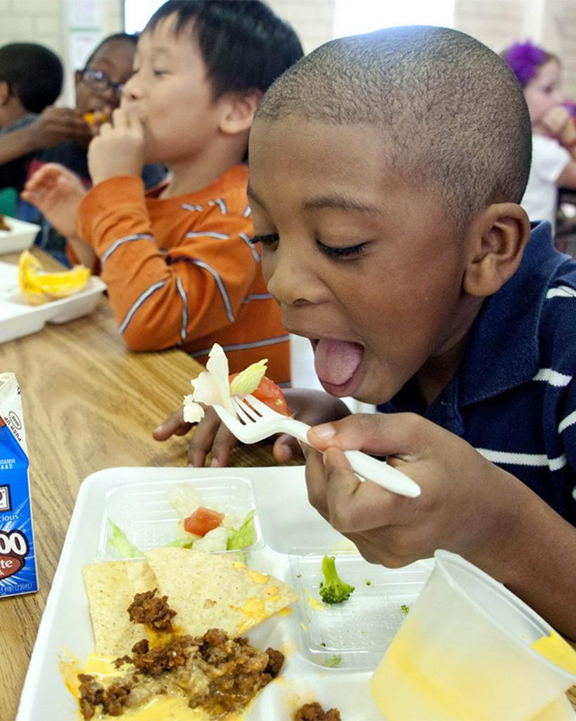 Kid eats school lunch