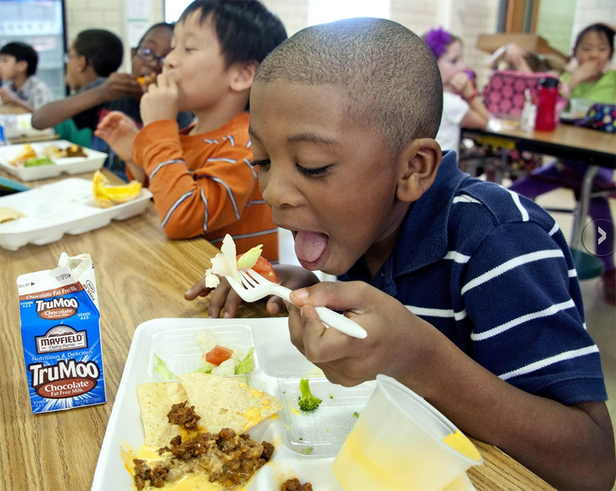 Kids eat lunch in a cafeteria
