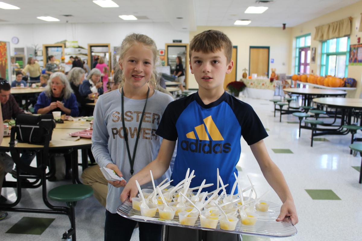 Kids holding snacks in a cafeteria