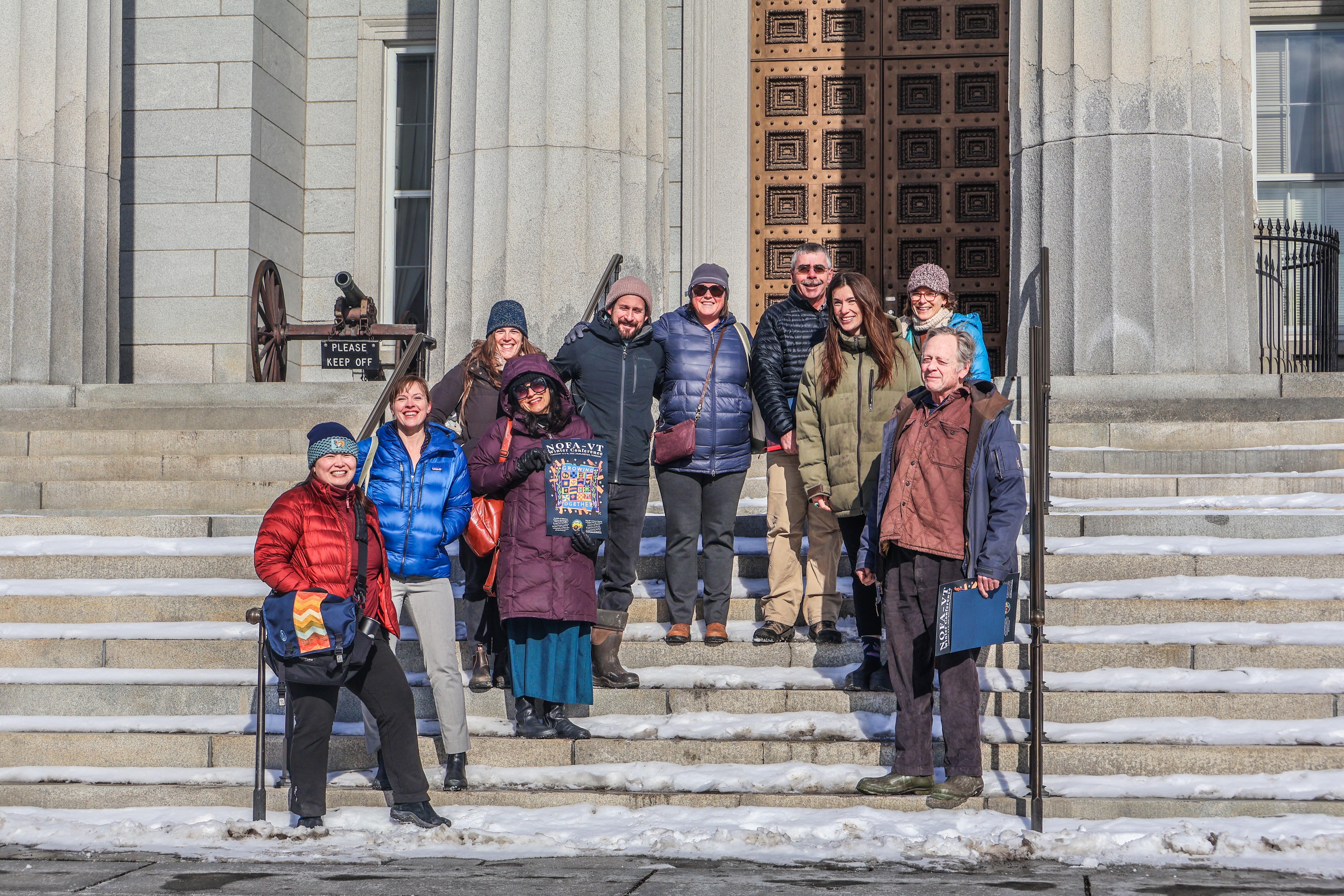 NOFA-VT Board members, along with NOFA-VT Executive Director Grace Oedel and NOFA-VT Deputy Director of Programs and Operations Helen Rortvedt on the steps of the Statehouse for a Board Advocacy Day in support of the Farm Security Fund 