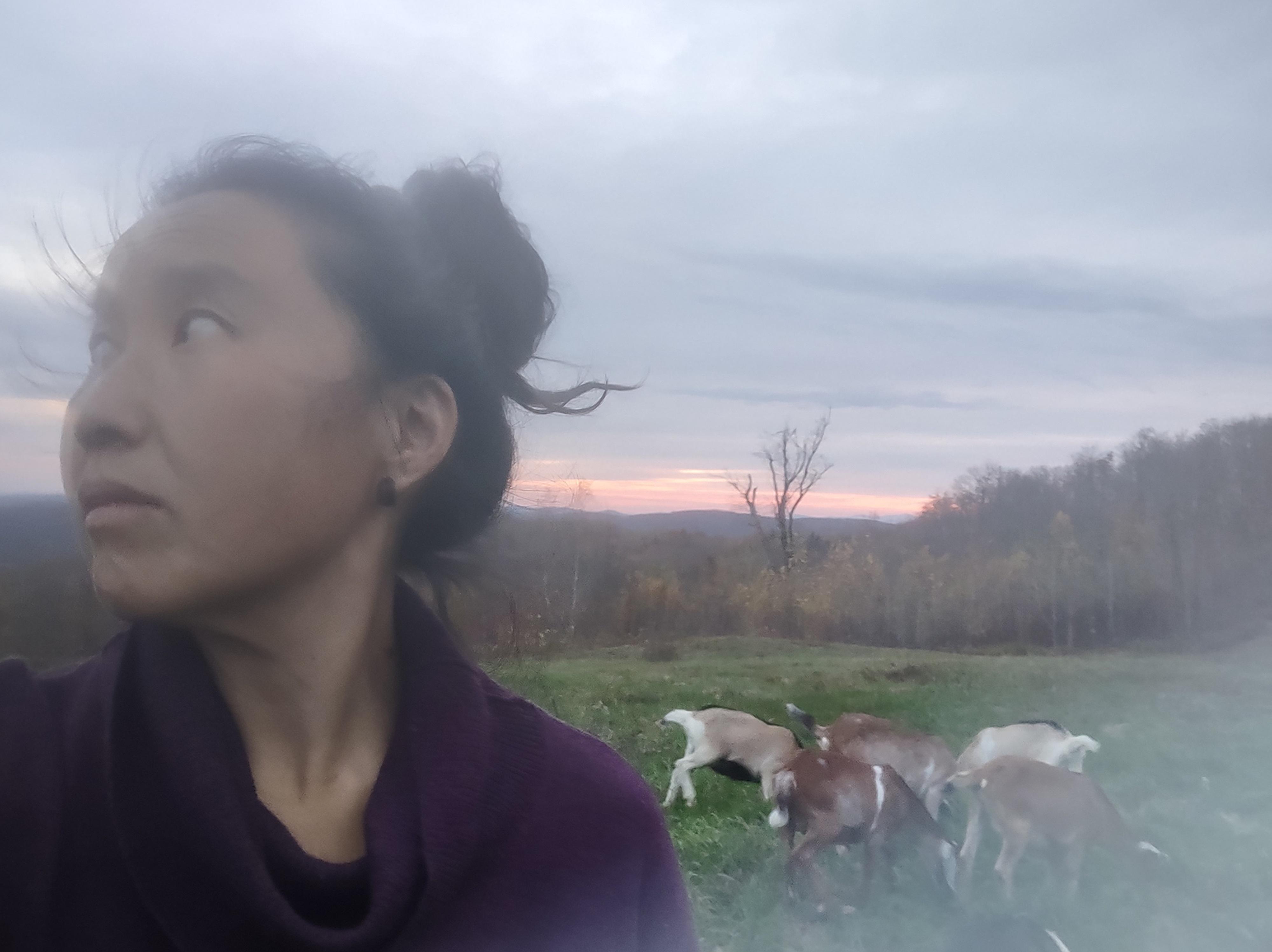 Sasha Hom headshot with goats 