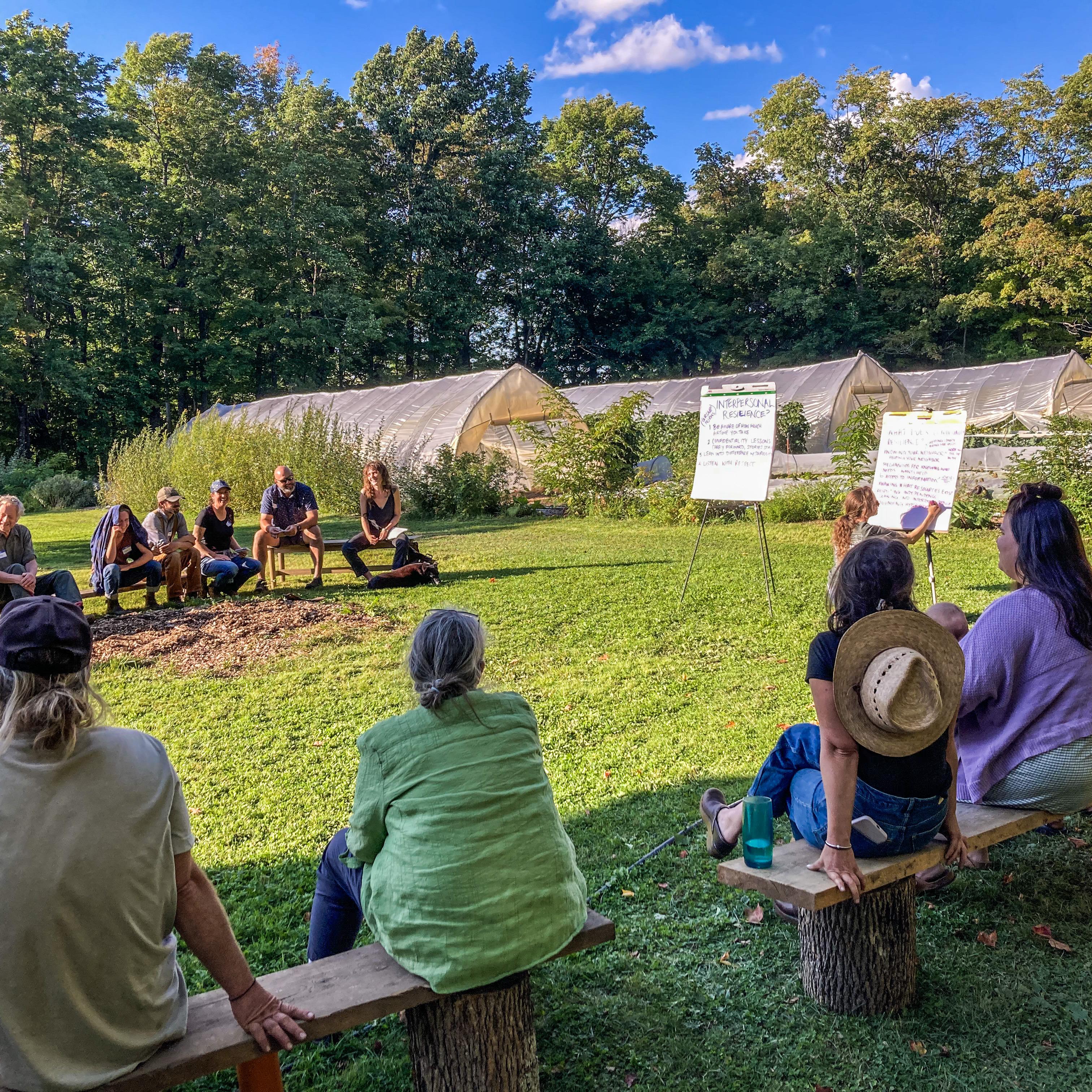 A group of farmers and other food system stakeholders gathered in a circle at Breadseed Farm for a resilience project meeting