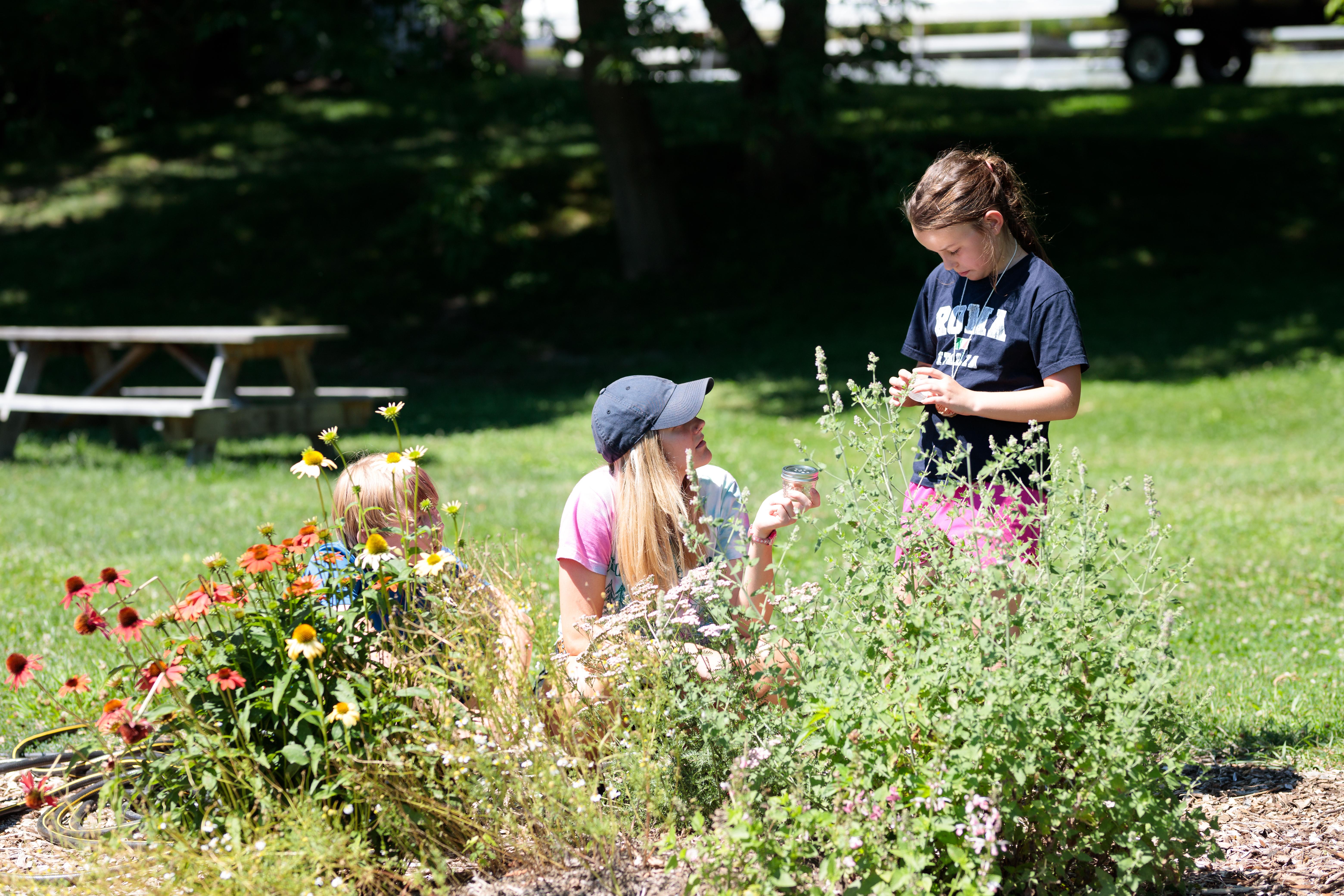 Educator and children in flowers