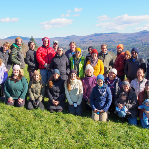 The NOFA-VT staff and board stands outside in a group, smiling at the camera.