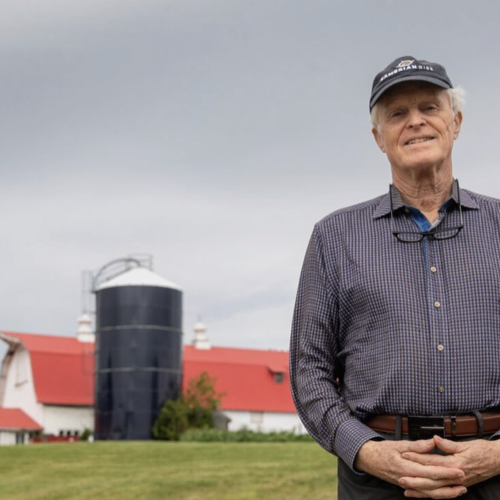 Will Raap stands outside on a dairy farm