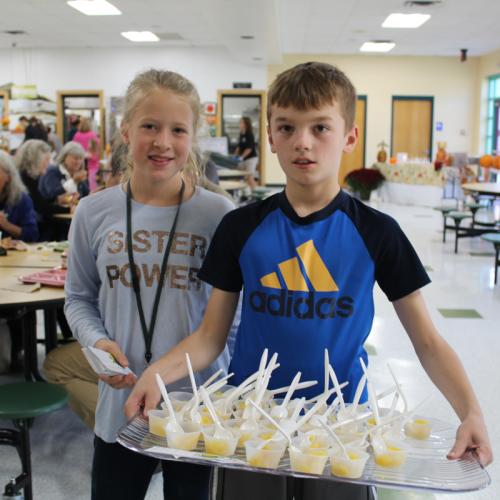 Kids holding snacks in a cafeteria