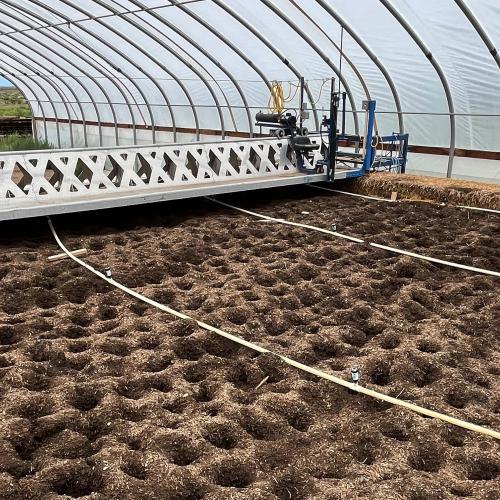 Johnson Su composting system pictured in a high-tunnel
