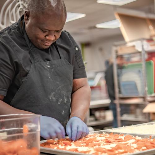 Thristan Coke, a Vermont school nutrition professional, makes pizza from scratch with local, organic grains at the Westminster Center School. Photo by Kimberly Kaufman