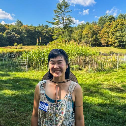 Laura Xiao of By Hand Farm stands beaming before her fields of flowers