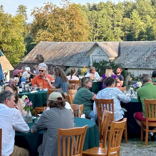 group sitting at picnic tables at farm