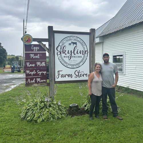 farmers in front of sign