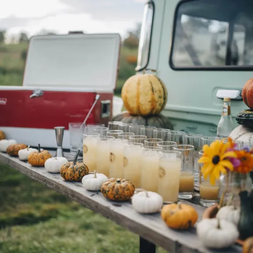 pumpkins and drinks on the back of a vintage land rover